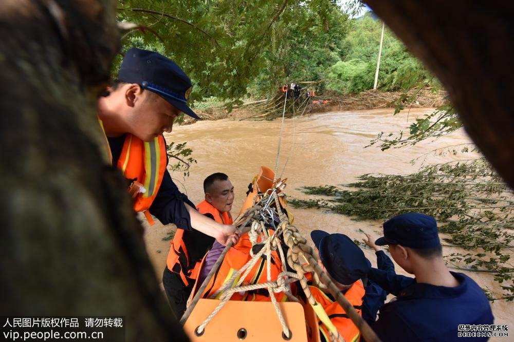 6月13日，消防救援大隊(duì)正在從河對面救援被洪水圍困的雙目失明的老人。